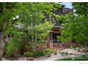 Charming stone-clad home with mature trees and inviting curb appeal at 788 Grant Pl, Boulder, CO 80302