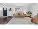Bright living room with hardwood floors, a large window, and neutral decor at 8290 Chase Way, Arvada, CO 80003