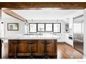 Modern kitchen with a large island, stainless steel appliances, and hardwood floors at 920 Hawthorn Ave, Boulder, CO 80304