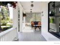 Inviting porch with comfortable seating, hanging plants, and decorative lighting fixtures at 920 Hawthorn Ave, Boulder, CO 80304