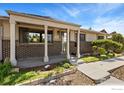 Inviting front porch with brick accents, manicured garden, and updated walkway leads to a cozy home at 9598 Lowell Blvd, Westminster, CO 80031