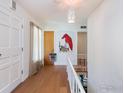 Bright hallway with hardwood floors, unique art, and a staircase leading to another level at 1035 Rosehill Dr, Boulder, CO 80302