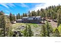 Beautiful exterior view of a home featuring a large deck and mountain views at 1100 Deer Trail Rd, Boulder, CO 80302