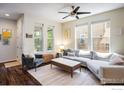 Comfortable living room featuring a plush sofa, stylish decor, and large windows that brighten the space at 11033 E 28Th Pl, Denver, CO 80238