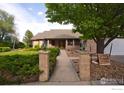 Charming home with a landscaped walkway and brick pillar accents at 1314 State Highway 66 Hwy, Longmont, CO 80504