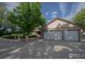 Spacious home featuring an attached three-car garage and paved driveway at 1314 State Highway 66 Hwy, Longmont, CO 80504
