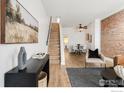 Bright living room with wood floors, staircase, dining area, stylish decor, and comfortable seating at 135 E 8Th Ave, Denver, CO 80203