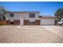 Inviting two-story home with an attached garage and low-maintenance gravel front yard at 15904 E Bates Pl, Aurora, CO 80013