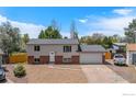 Charming two-story home with a gravel yard, attached garage, and inviting curb appeal at 15904 E Bates Pl, Aurora, CO 80013