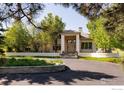 Beautiful home exterior featuring manicured landscaping, elegant entryway, and circular driveway at 160 Ponderosa Dr, Boulder, CO 80303