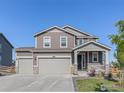 Charming two-story home featuring a welcoming front porch and a three-car garage at 1953 Morgan Dr, Erie, CO 80516