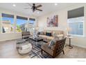 Bright living room with neutral decor, large windows and stylish furnishings at 1953 Morgan Dr, Erie, CO 80516