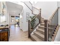 Inviting foyer featuring a staircase with carpeted steps and wooden handrails at 1953 Morgan Dr, Erie, CO 80516