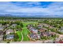 Aerial view highlights the home's setting near green spaces and mountains within a vibrant community at 2369 Hecla Dr, Louisville, CO 80027