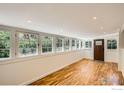 Bright living room features wood floors and large windows offering a great view of nature at 29 Silver Spruce, Boulder, CO 80302