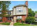 Charming red brick townhome exterior with a well-manicured lawn and inviting entrance at 3022 W 107Th Pl # D, Westminster, CO 80031