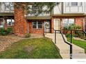 Charming red brick townhome exterior with a well-manicured lawn and inviting entrance at 3022 W 107Th Pl # D, Westminster, CO 80031