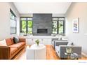 Sun-filled living room with a striking stone fireplace and stylish modern furniture at 3470 16Th Cir, Boulder, CO 80304