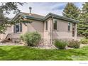 A beautifully landscaped backyard with lush green grass, mature trees, and a rock garden for relaxation at 4326 Clay Commons Ct, Boulder, CO 80303