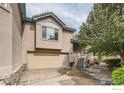 Inviting two-story home with a beige exterior, attached garage, and well-manicured yard for curb appeal at 4326 Clay Commons Ct, Boulder, CO 80303