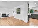 Open-concept living room featuring hardwood floors, a fireplace, and large windows at 4658 Ingram Ct, Boulder, CO 80305
