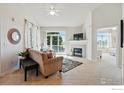 Cozy living room with a fireplace and access to a private outdoor patio at 612 Wild Ridge Ln, Lafayette, CO 80026