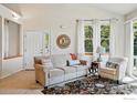 Comfortable living room featuring a sofa and a decorative mirror and sun-lit windows at 612 Wild Ridge Ln, Lafayette, CO 80026