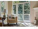 Bright living room with a sliding glass door leading to an outdoor deck at 612 Wild Ridge Ln, Lafayette, CO 80026