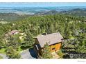 Mountain home boasts scenic views nestled among the trees with a long drive at 84 Canon View Rd, Boulder, CO 80302