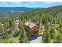 Aerial view of a mountain home nestled in a wooded area with scenic views at 84 Canon View Rd, Boulder, CO 80302