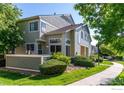 Well-maintained townhome featuring attractive landscaping and a sidewalk at 930 Button Rock Dr # 28, Longmont, CO 80504