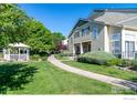 Charming home with well-kept lawn, walkway, mature trees, and relaxing gazebo at 930 Button Rock Dr # 28, Longmont, CO 80504