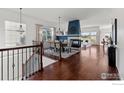 View of the dining room featuring hardwood floors, a fireplace and views through large windows at 102 Ortega Ct, Erie, CO 80516