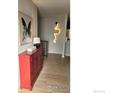 A modern entryway with a striking red credenza and unique lighting at 1087 Lilac St, Broomfield, CO 80020