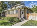 Beautiful vintage brick home with mature landscaping and a well-manicured lawn at 1230 S Emerson St, Denver, CO 80210