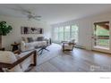 Bright living room with modern furnishings, natural light, and a door to the deck at 133 Mine Ln, Boulder, CO 80302