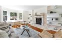 Bright living room with fireplace, built-in shelves, hardwood floors and many windows at 133 Mine Ln, Boulder, CO 80302