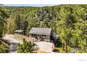 Charming home with a metal roof, lovely landscaping, and inviting front entrance and fenced yard at 141 Millionaire W Dr, Boulder, CO 80302