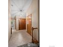 The entryway showcases a tiled floor, chandelier, and paneled doors, offering a warm invitation inside at 1528 16Th Pl, Longmont, CO 80501