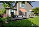 Charming home featuring a backyard deck, perfect for outdoor dining and relaxation in a serene setting at 1574 Goshawk Dr, Longmont, CO 80504