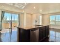 Modern kitchen island with granite countertops, stainless steel appliances, and a breakfast bar at 17616 Bluetrail Ave, Parker, CO 80134