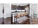 Modern kitchen with granite countertops, stainless steel appliances, and breakfast bar seating at 17616 Bluetrail Ave, Parker, CO 80134