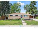 Well-maintained ranch-style home with a manicured lawn, mature trees, and inviting curb appeal at 1880 E 84Th Ave, Denver, CO 80229