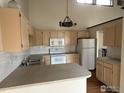Bright kitchen with white appliances and traditional cabinets at 1943 Meadow Dr # B2, Longmont, CO 80501