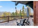 Relax on this deck with Adirondack chairs, side tables, and stunning mountain views at 216 N Gold Flake, Breckenridge, CO 80424
