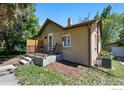 Exterior angle of a single-Gathering house with charming porch and green surroundings at 2200 Teller St, Lakewood, CO 80214
