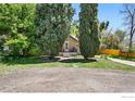 A quaint home with lush greenery and mature trees surrounding the property at 2200 Teller St, Lakewood, CO 80214