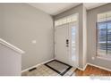 Bright entryway features tile flooring, natural light, and a welcoming front door with sidelights at 2855 Rock Creek Cir # 200, Superior, CO 80027