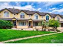 Charming townhomes with bright yellow exteriors, well-manicured lawns, and beautiful landscaping at 2855 Rock Creek Cir # 200, Superior, CO 80027