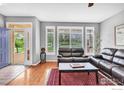 Inviting living room featuring hardwood floors, ample natural light, and comfortable leather seating at 2855 Rock Creek Cir # 200, Superior, CO 80027